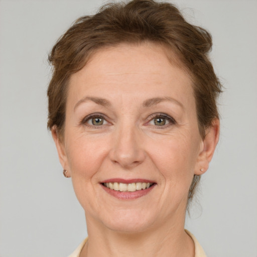 Joyful white adult female with short  brown hair and grey eyes