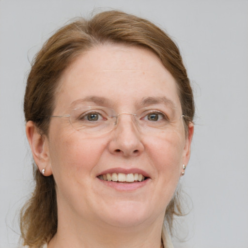 Joyful white adult female with medium  brown hair and blue eyes