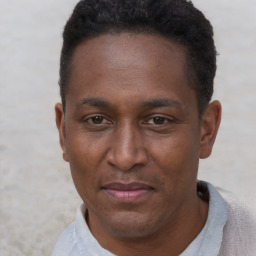 Joyful black adult male with short  black hair and brown eyes