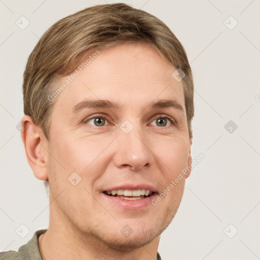 Joyful white adult male with short  brown hair and grey eyes