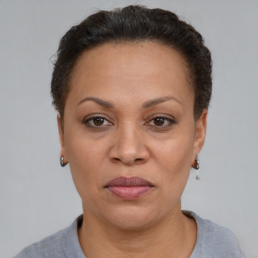 Joyful latino adult female with short  brown hair and brown eyes