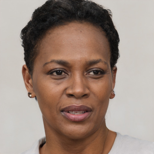 Joyful black adult female with short  black hair and brown eyes