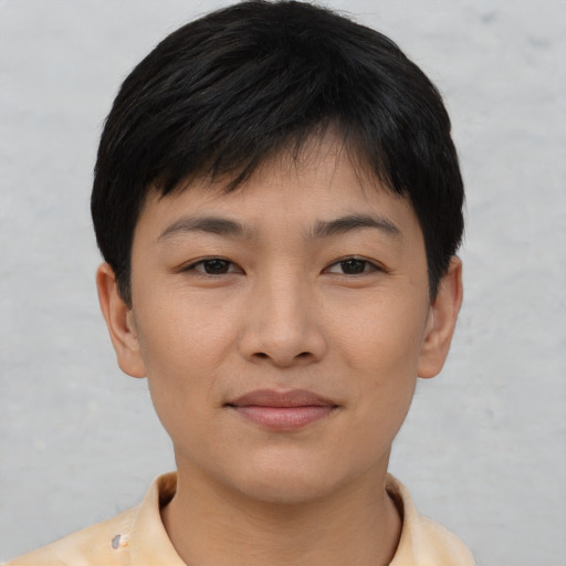 Joyful asian young-adult female with short  brown hair and brown eyes