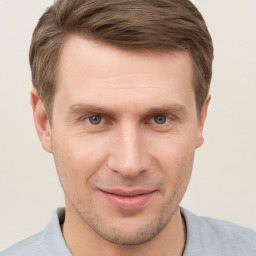 Joyful white young-adult male with short  brown hair and grey eyes