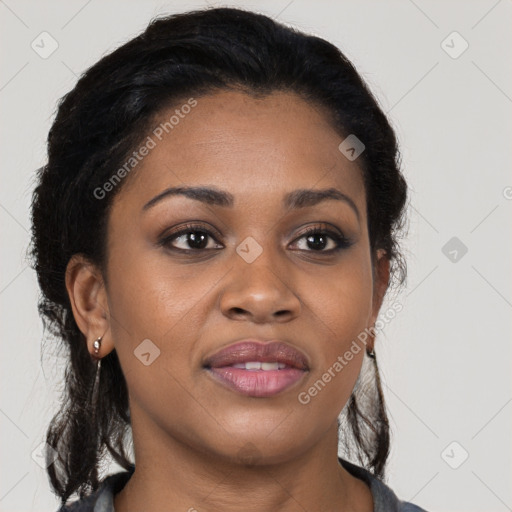 Joyful black young-adult female with long  black hair and brown eyes