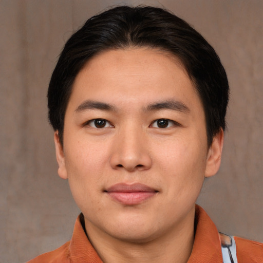 Joyful asian young-adult male with medium  brown hair and brown eyes