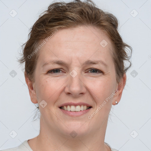 Joyful white adult female with short  brown hair and grey eyes