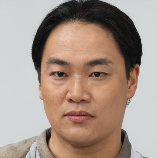 Neutral asian adult male with short  black hair and brown eyes