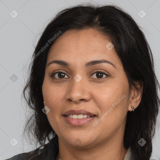 Joyful latino adult female with medium  brown hair and brown eyes