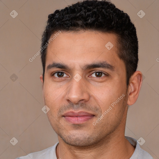 Joyful white young-adult male with short  black hair and brown eyes