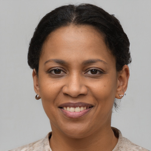 Joyful latino young-adult female with short  brown hair and brown eyes