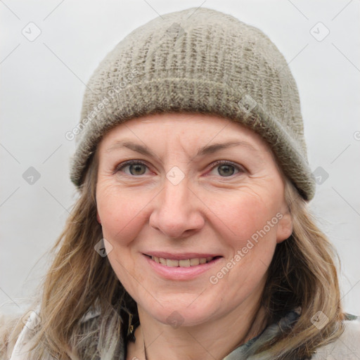 Joyful white adult female with medium  brown hair and grey eyes