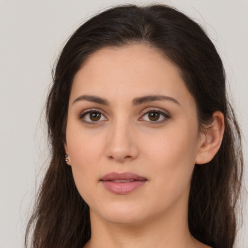 Joyful white young-adult female with long  brown hair and brown eyes