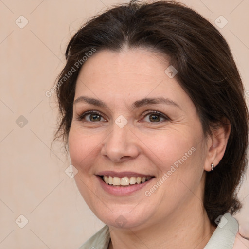 Joyful white adult female with medium  brown hair and brown eyes