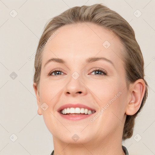 Joyful white young-adult female with medium  brown hair and blue eyes