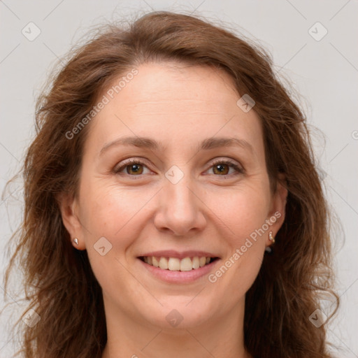 Joyful white adult female with long  brown hair and brown eyes