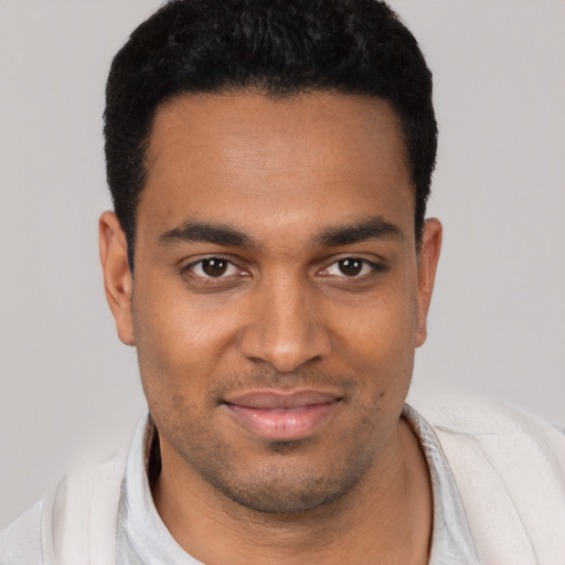 Joyful latino young-adult male with short  black hair and brown eyes