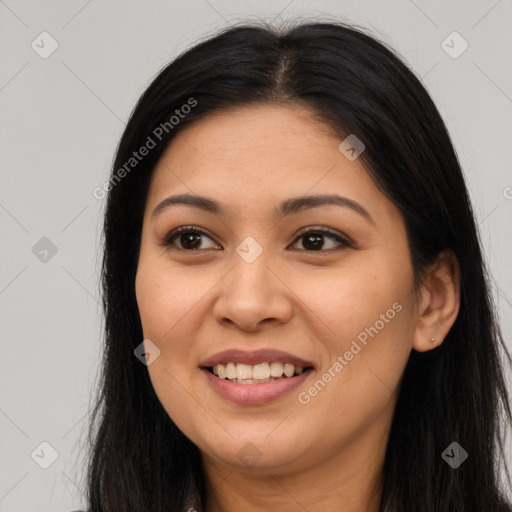 Joyful latino young-adult female with long  brown hair and brown eyes