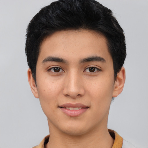 Joyful asian young-adult male with short  black hair and brown eyes