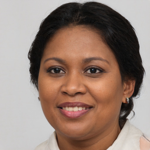 Joyful black adult female with medium  brown hair and brown eyes