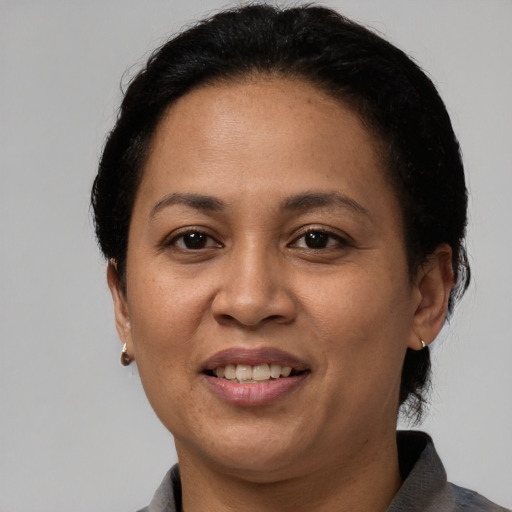 Joyful latino adult female with short  black hair and brown eyes