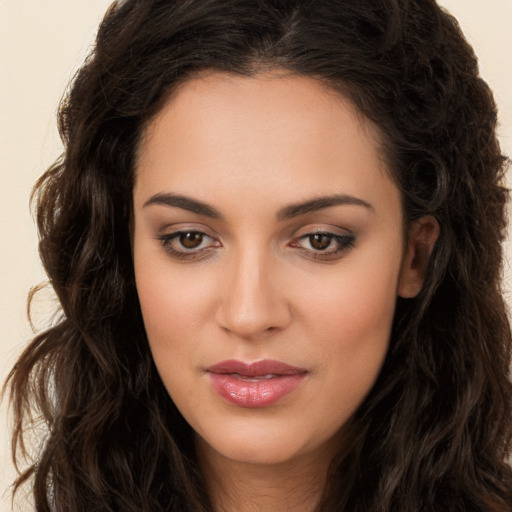 Joyful white young-adult female with long  brown hair and brown eyes