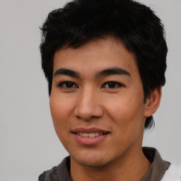 Joyful asian young-adult male with short  black hair and brown eyes