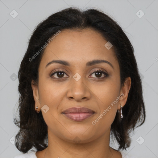 Joyful latino adult female with medium  brown hair and brown eyes