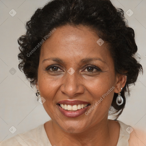 Joyful black adult female with medium  brown hair and brown eyes