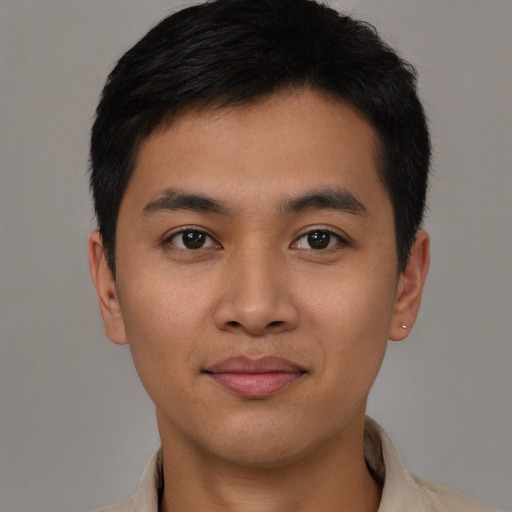 Joyful asian young-adult male with short  black hair and brown eyes