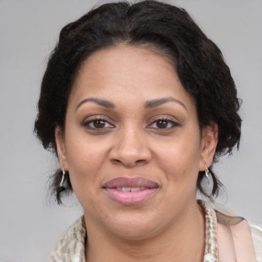 Joyful latino adult female with medium  brown hair and brown eyes