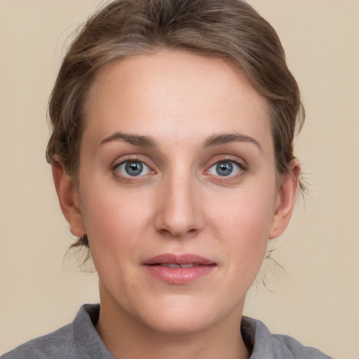 Joyful white young-adult female with medium  brown hair and blue eyes