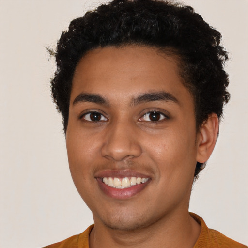 Joyful latino young-adult male with short  brown hair and brown eyes