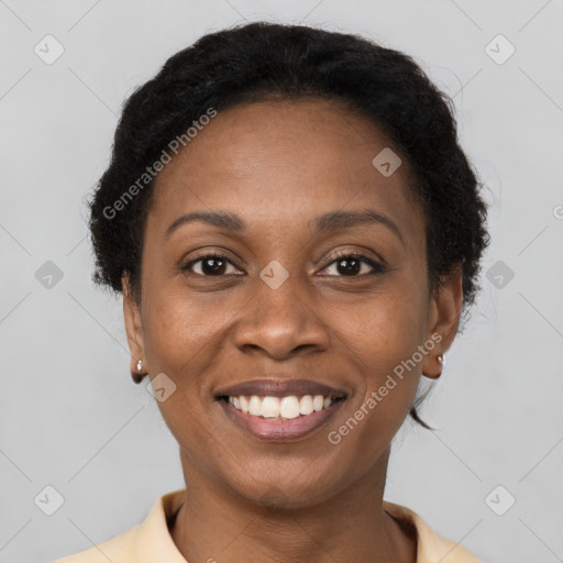 Joyful black young-adult female with short  brown hair and brown eyes