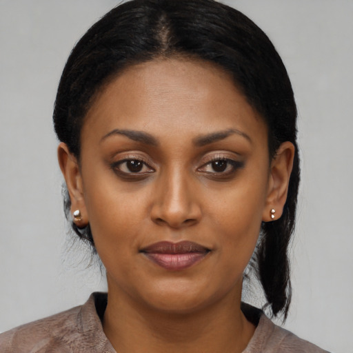 Joyful black young-adult female with medium  black hair and brown eyes
