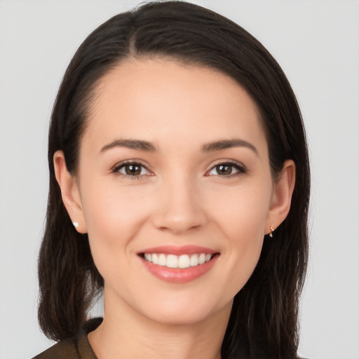 Joyful white young-adult female with long  brown hair and brown eyes