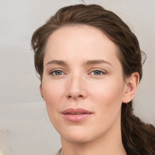 Joyful white young-adult female with medium  brown hair and grey eyes