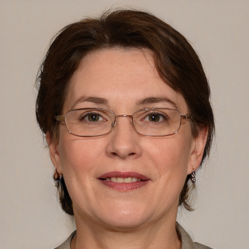 Joyful white adult female with medium  brown hair and grey eyes