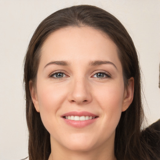 Joyful white young-adult female with long  brown hair and grey eyes