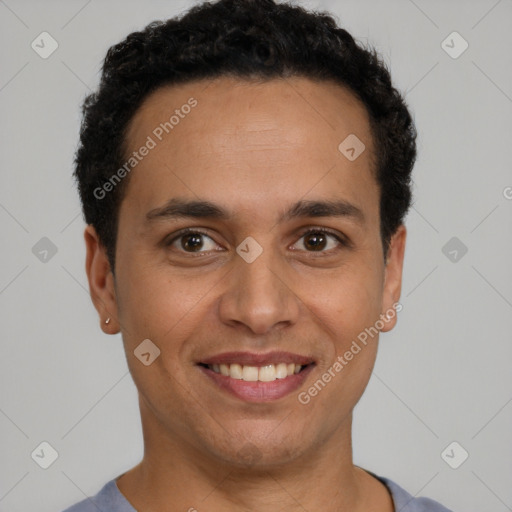 Joyful latino young-adult male with short  black hair and brown eyes