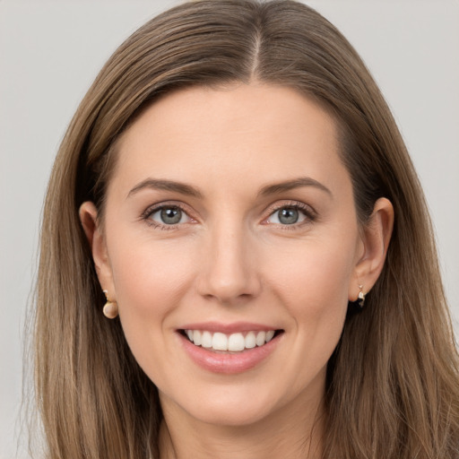 Joyful white young-adult female with long  brown hair and grey eyes