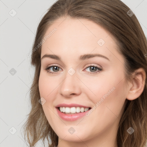 Joyful white young-adult female with long  brown hair and grey eyes