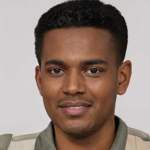 Joyful black young-adult male with short  black hair and brown eyes
