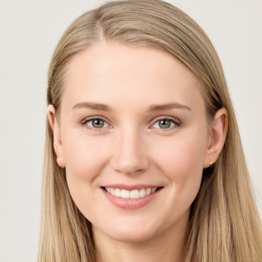 Joyful white young-adult female with long  brown hair and blue eyes