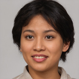 Joyful asian young-adult female with medium  brown hair and brown eyes