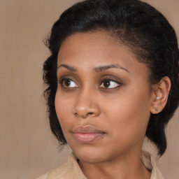 Joyful black young-adult female with medium  brown hair and brown eyes