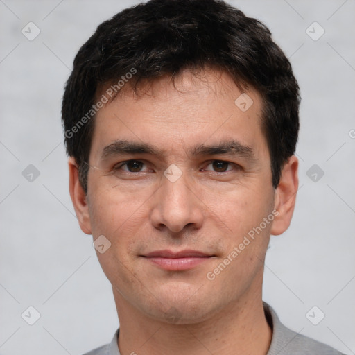 Joyful white young-adult male with short  black hair and brown eyes