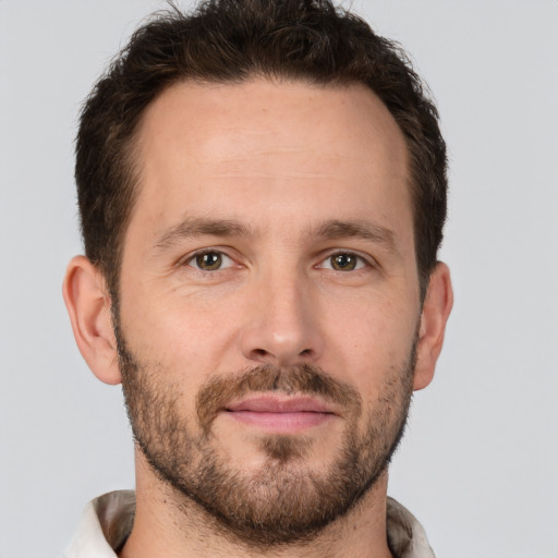 Joyful white adult male with short  brown hair and brown eyes