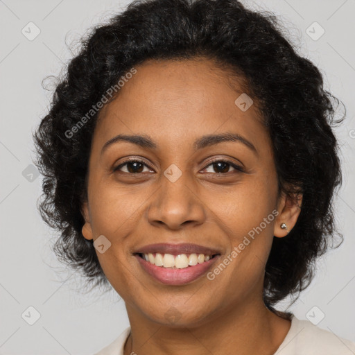 Joyful black young-adult female with long  brown hair and brown eyes