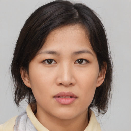 Neutral asian young-adult female with medium  brown hair and brown eyes